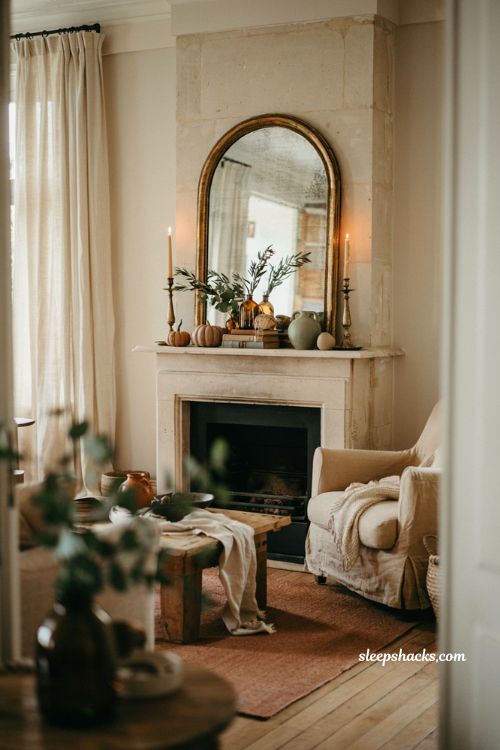 Fall mantel with oversized antique mirror candlelight and eucalyptus decor