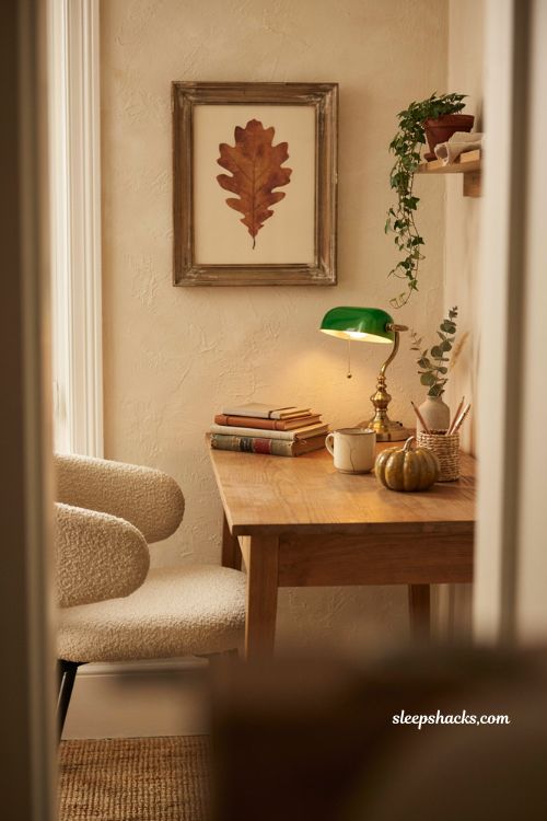 Fall office decor with framed autumn leaf wall art above a small desk 