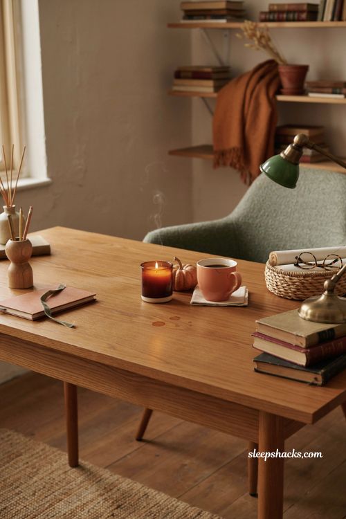 Fall office decor with scented candle pumpkin mug and cozy autumn desk