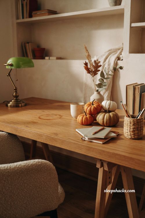 Fall office decor with small pumpkins in white orange and gold on a cozy desk