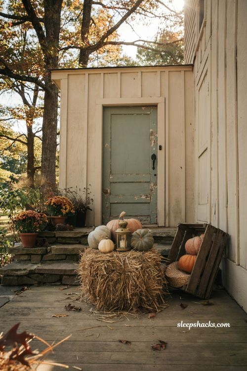 Fall porch decor with hay bales pumpkins mums and rustic autumn textures