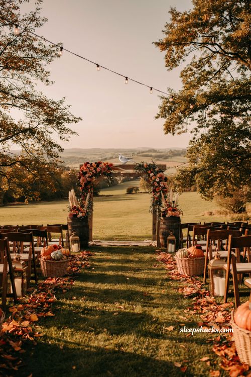 Fall wedding ideas with golden hour ceremony lighting and rustic autumn wedding arch