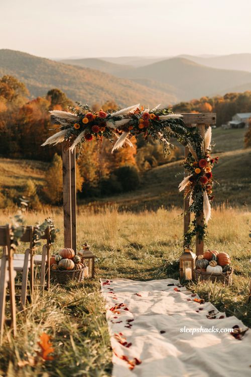 Fall wedding ideas with grounded autumn floral ceremony arch and mountain backdrop