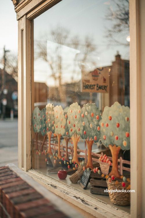 Fall window painting with apple orchard trees red green apples and harvest storefront decor