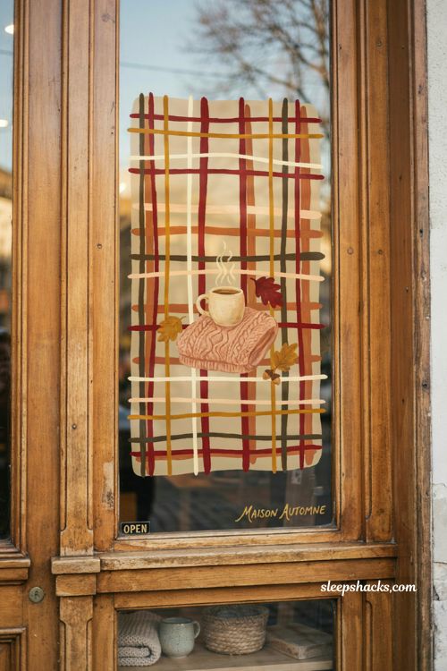 Fall window painting with plaid background cozy mug sweater weather and autumn storefront decor