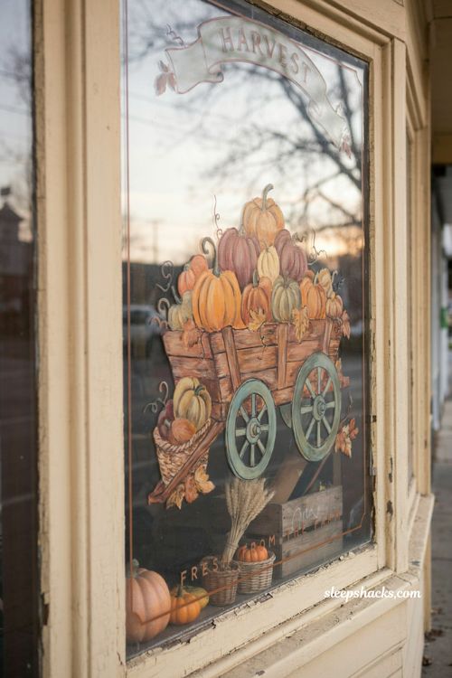 Fall window painting with rustic pumpkin wagon farm cart and cozy harvest storefront decor