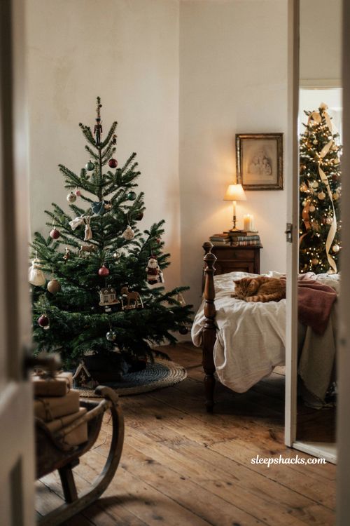 Family Christmas tree with vintage ornaments in a cozy Ralph Lauren style bedroom 