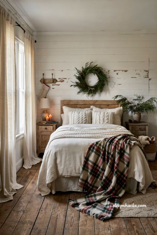 Farmhouse christmas bedroom with a cozy plaid throw layered across the bed