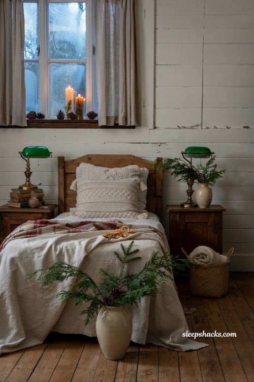 Farmhouse christmas bedroom with faux flickering candles glowing on the windowsill