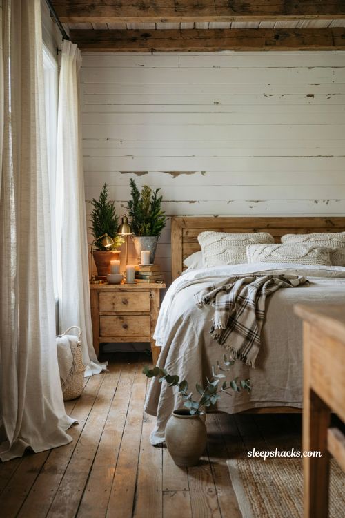 Farmhouse christmas bedroom with faux potted greenery on vintage nightstands