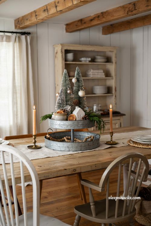 Farmhouse christmas dining room with a rustic tiered tray seasonal centerpiece