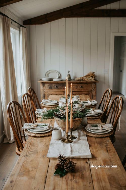 Farmhouse christmas dining room with boxwood wreaths tied to vintage dining chairs