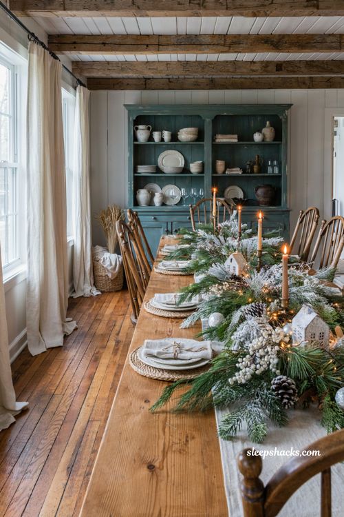 Farmhouse christmas dining room with flocked greenery and a snowy winter tablescape