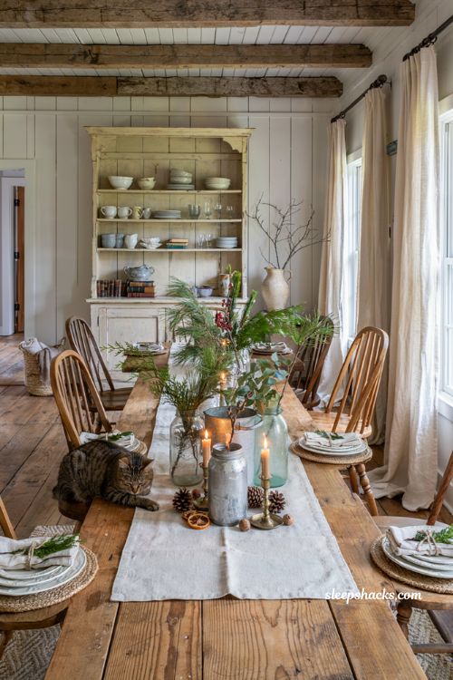 Farmhouse christmas dining table with vintage mason jars and fresh holiday greenery