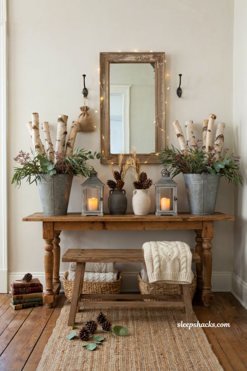 Farmhouse christmas entryway decor with birch logs and greenery in galvanized buckets