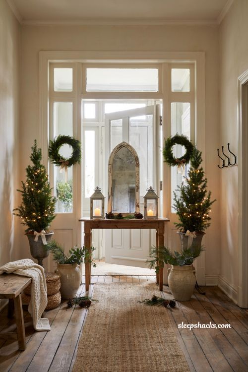 Farmhouse christmas entryway decor with layered rug and welcome mat styling