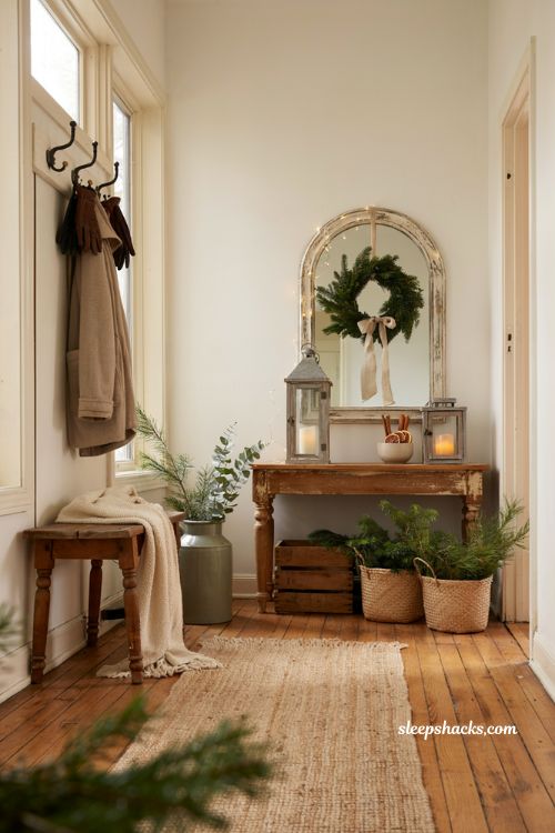Farmhouse christmas entryway decor with rustic console table and cozy holiday styling