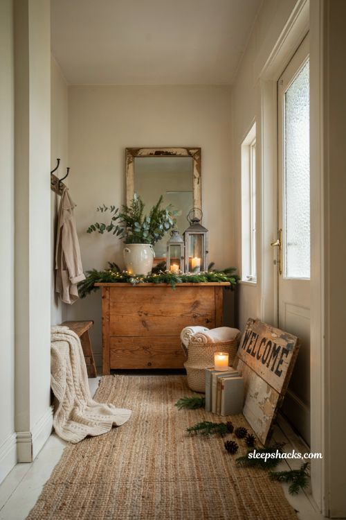 Farmhouse christmas entryway decor with rustic leaning welcome sign and cozy accents