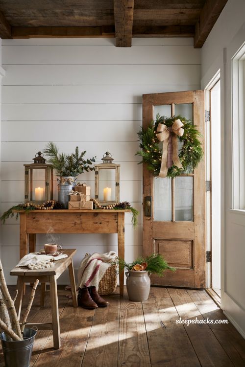 Farmhouse christmas entryway with layered burlap bows and rustic holiday ribbons