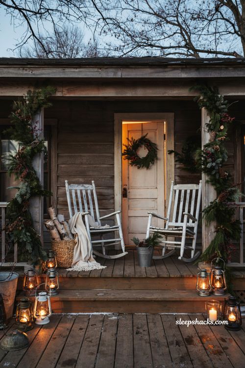 Farmhouse christmas porch with natural garland lanterns and cozy winter accents