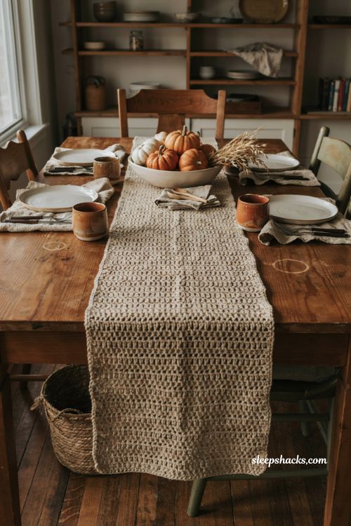 Farmhouse crochet table runner with textured oatmeal cotton clay tones gourds dried wheat and rustic dining table decor 