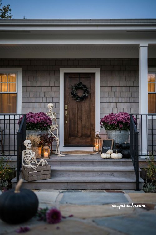 Farmhouse halloween porch ideas with black purple pumpkins and mums