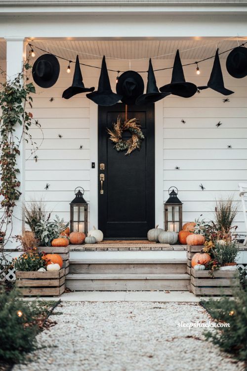 Farmhouse halloween porch ideas with floating witch hats and pumpkins