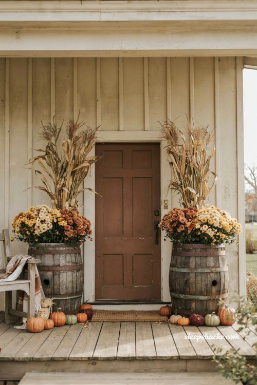 Faux mums in wooden barrel planters for a rustic fall front porch 