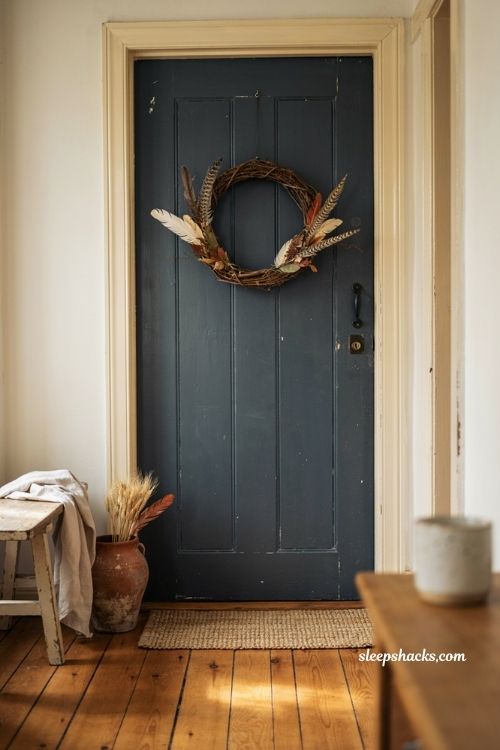 Feather and grapevine wreath with dried branches for vintage fall decor