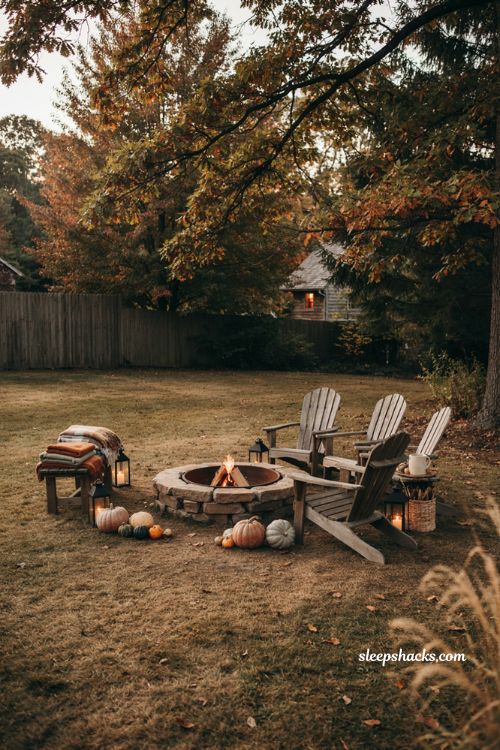 Firepit cozy fall corner with Adirondack chairs pumpkins folded blankets lanterns and rustic autumn outdoor decor 
