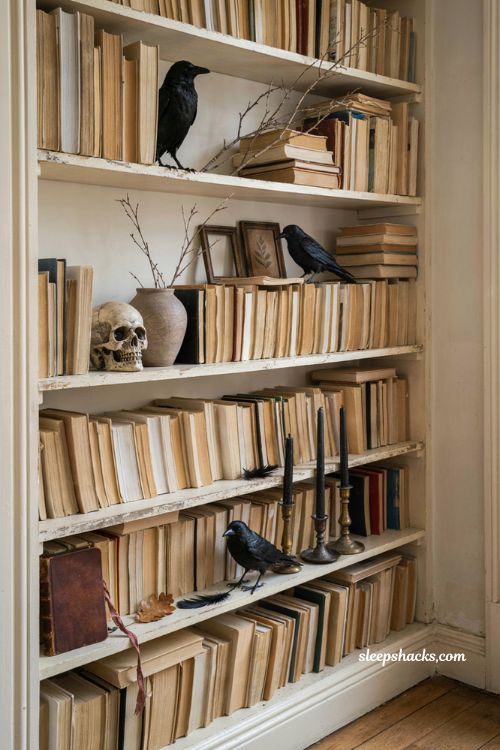 Flipped books with black crows for neutral Halloween bookshelf decor 