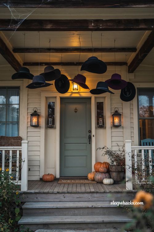 Floating witch hat Halloween porch decor with pumpkins and cozy autumn style