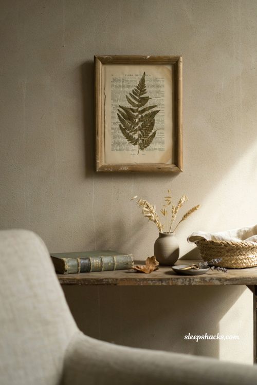 Framed pressed leaf art with vintage book page background