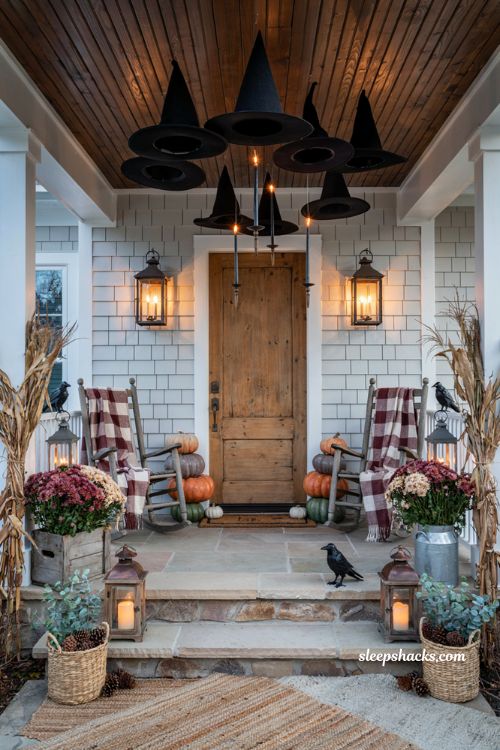 Front porch halloween ideas with floating witch hats lanterns and cozy autumn decor