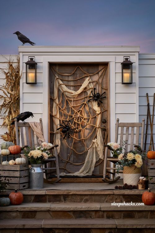 Front porch halloween ideas with giant spider web front door and cozy farmhouse style
