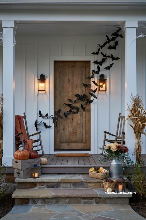 Front porch halloween ideas with hanging bats and cozy farmhouse decor