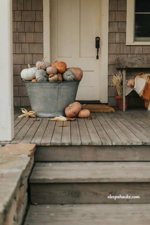 Galvanized buckets with pumpkins for a rustic fall front porch 