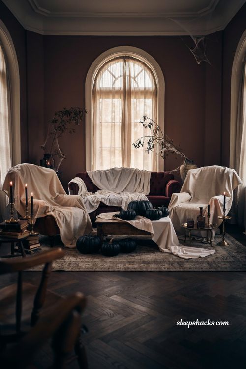 Ghostly furniture covers with white sheets for cozy Halloween house party decor