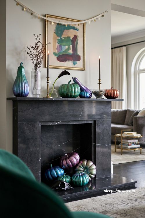 Glamorous metallic Halloween fireplace decor with jewel tone pumpkins