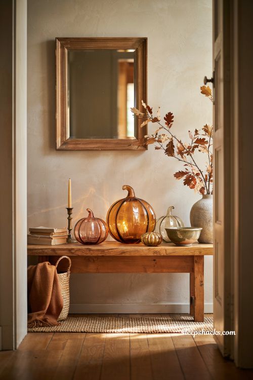 Glass pumpkin decor ideas for a cozy autumn entryway table with elegant amber accents