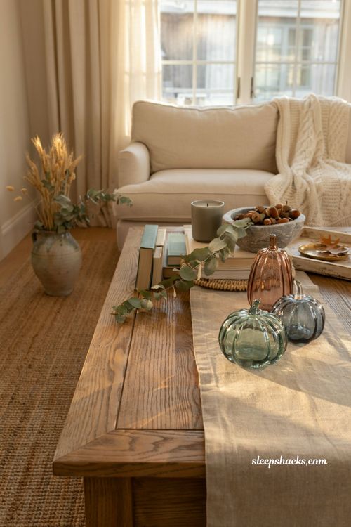 Glass pumpkin decor ideas for a modern farmhouse coffee table with soft green glass accents