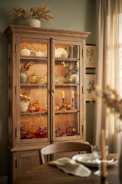 Glass pumpkin decor ideas for a vintage display cabinet with elegant autumn glass collection