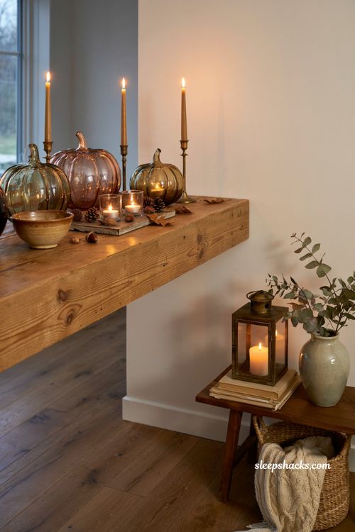 Glass pumpkin decor ideas with candlelight for a cozy autumn evening mantel display