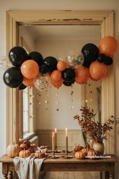 Gold star garland accent with black and orange Halloween balloon cluster and cozy pair
