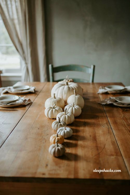 Graduated white pumpkin centerpiece with different sizes for a simple fall table 