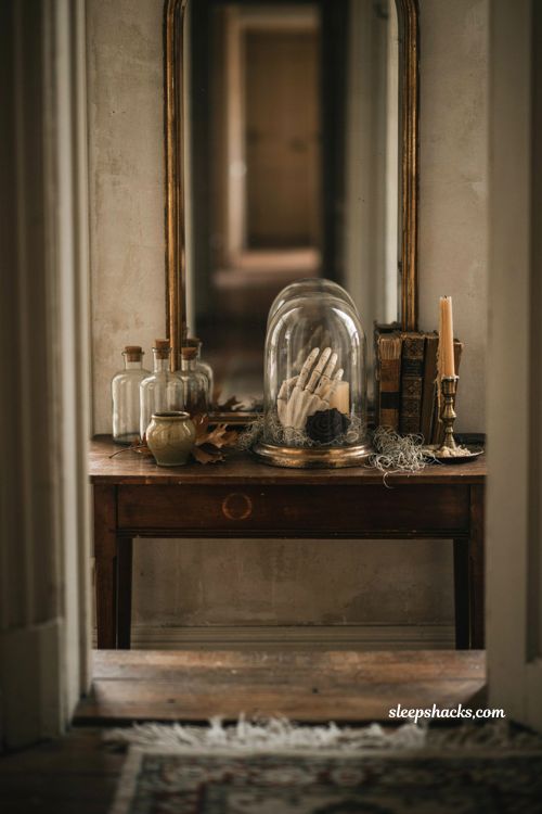 Halloween apothecary entryway decor with glass cloche skeleton hand and moss