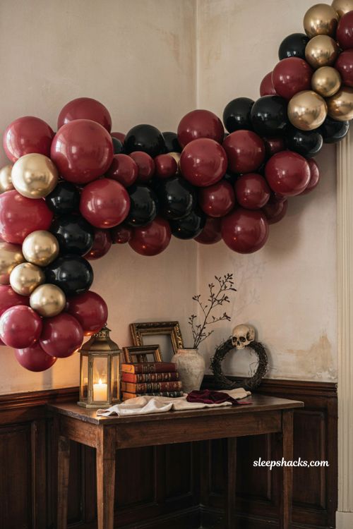 Halloween balloon garland with black burgundy and gold moody decor