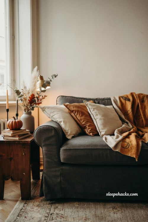 Halloween blanket draped over sofa arm cozy fall living room decor 