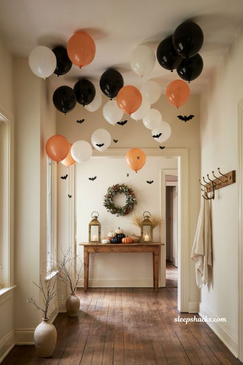 Halloween ceiling hanging balloon installation with floating bats and orange black decor