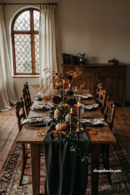 Halloween dining table decor with dark flowers autumn foliage ivy and burgundy blooms